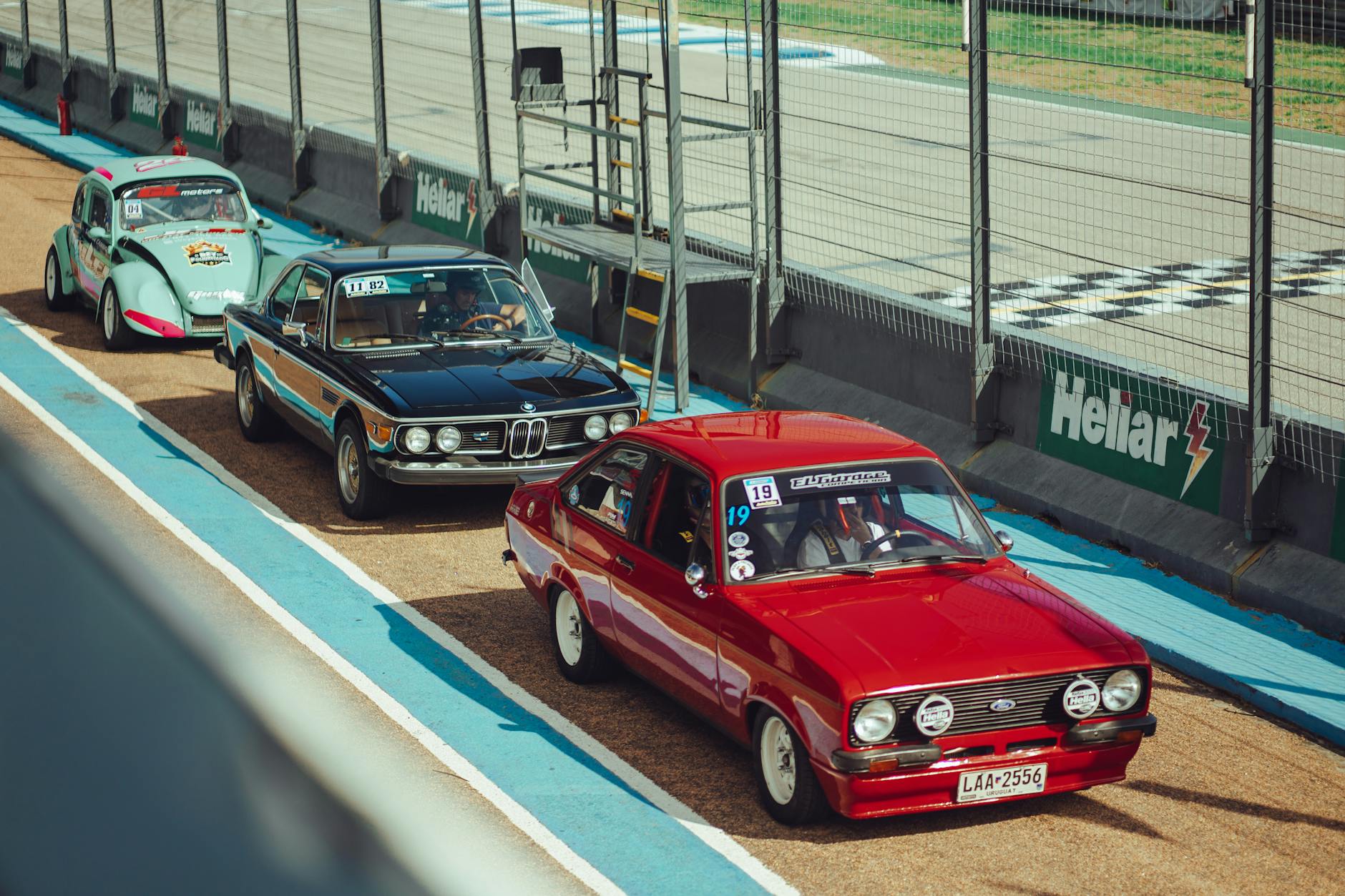 vintage racing cars in pit lane